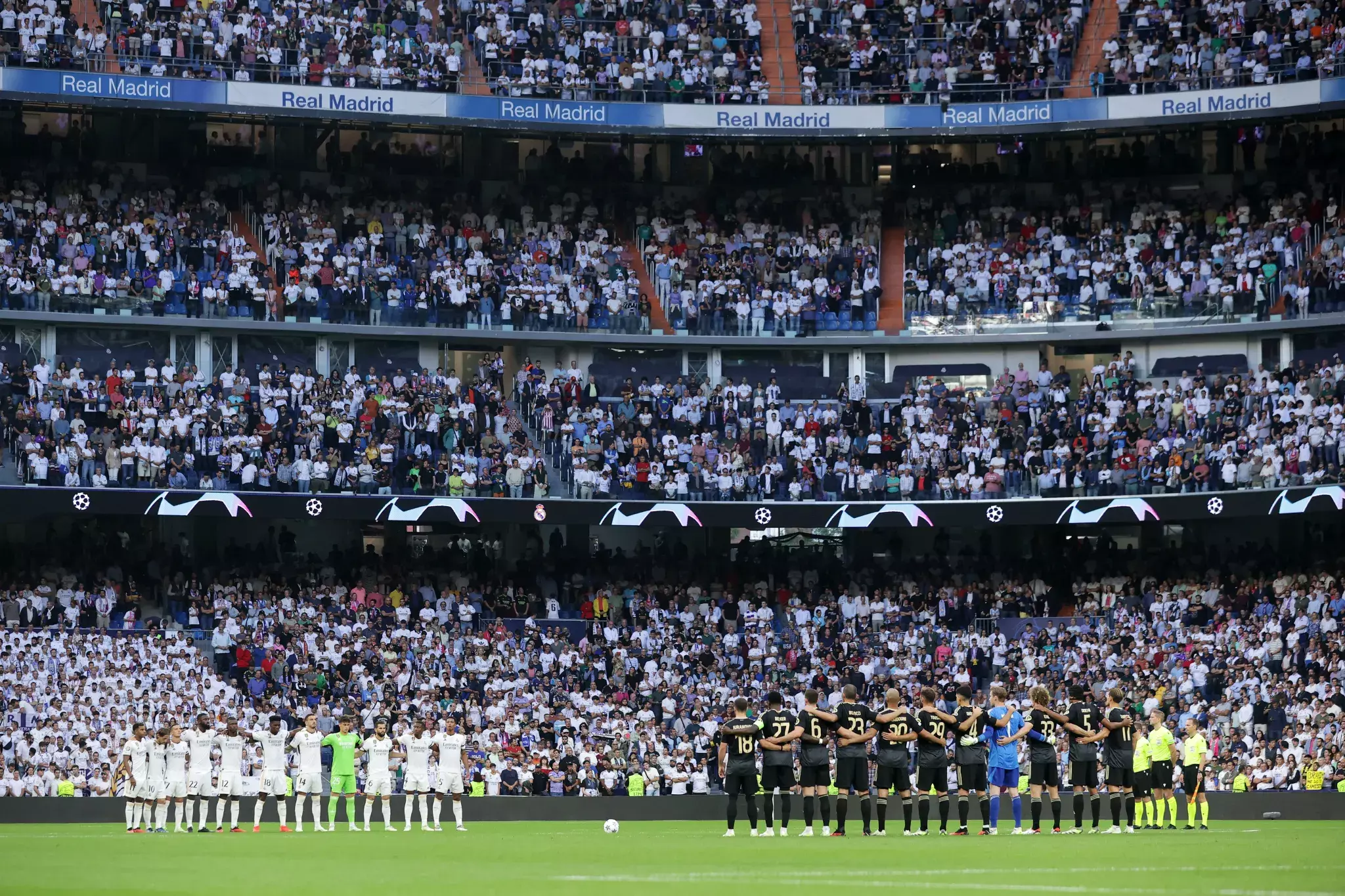 The Santiago Bernabeu during the Champions League. The camera shows the players at the field level from a position that is currently inaccessible to fans.