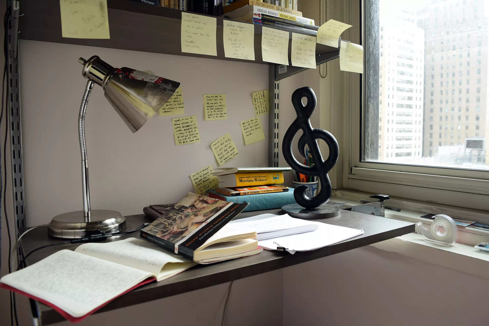 A black Sol stand on a messy desk.